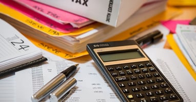 Tax documents, calculator, and paperwork for financial planning.