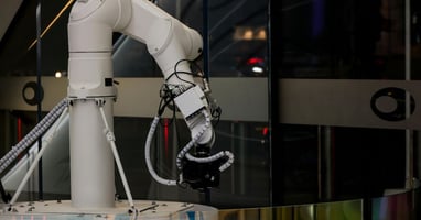 Robotic arm with camera used in AI automation.